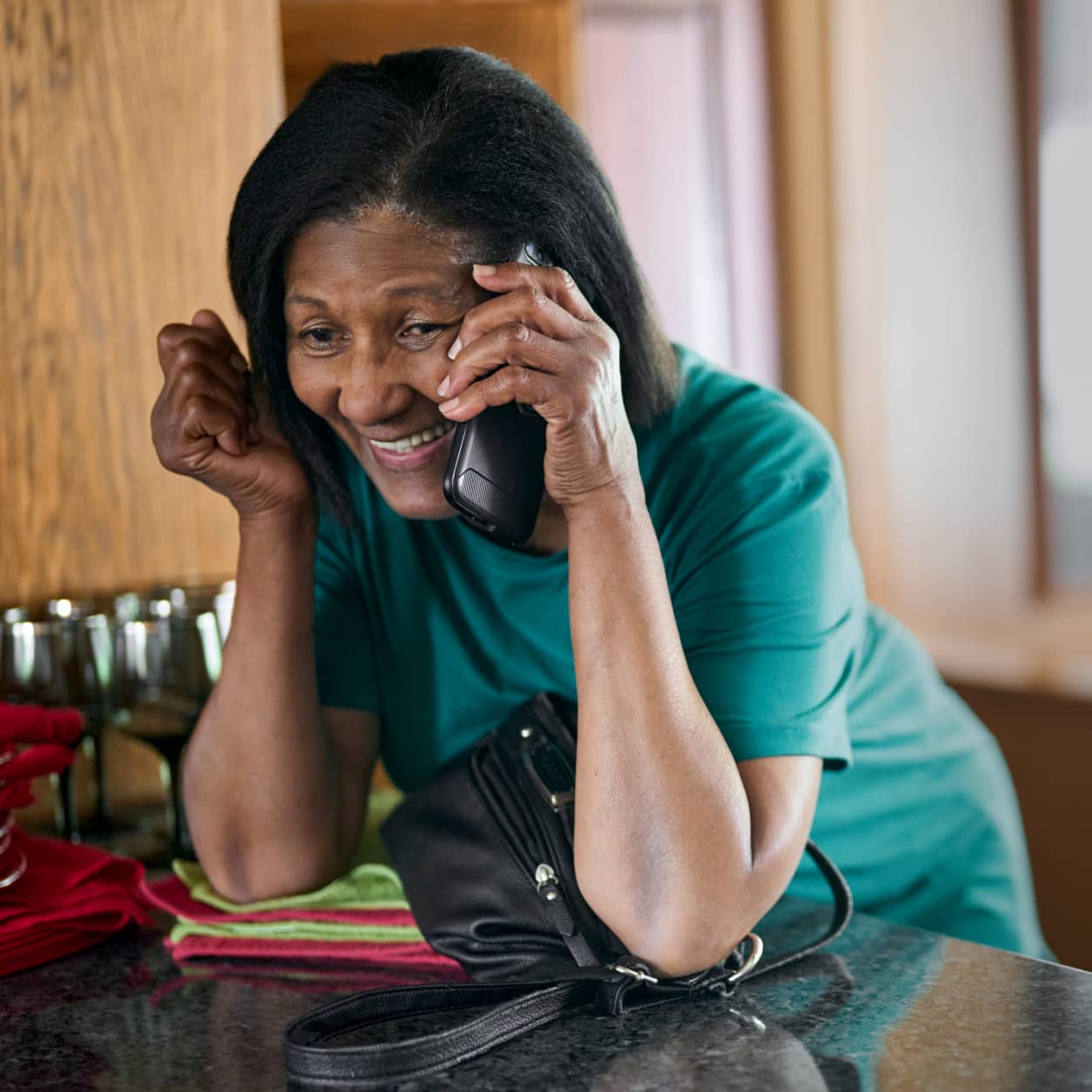 A person smiling while on their cellphone with their CareTeam.