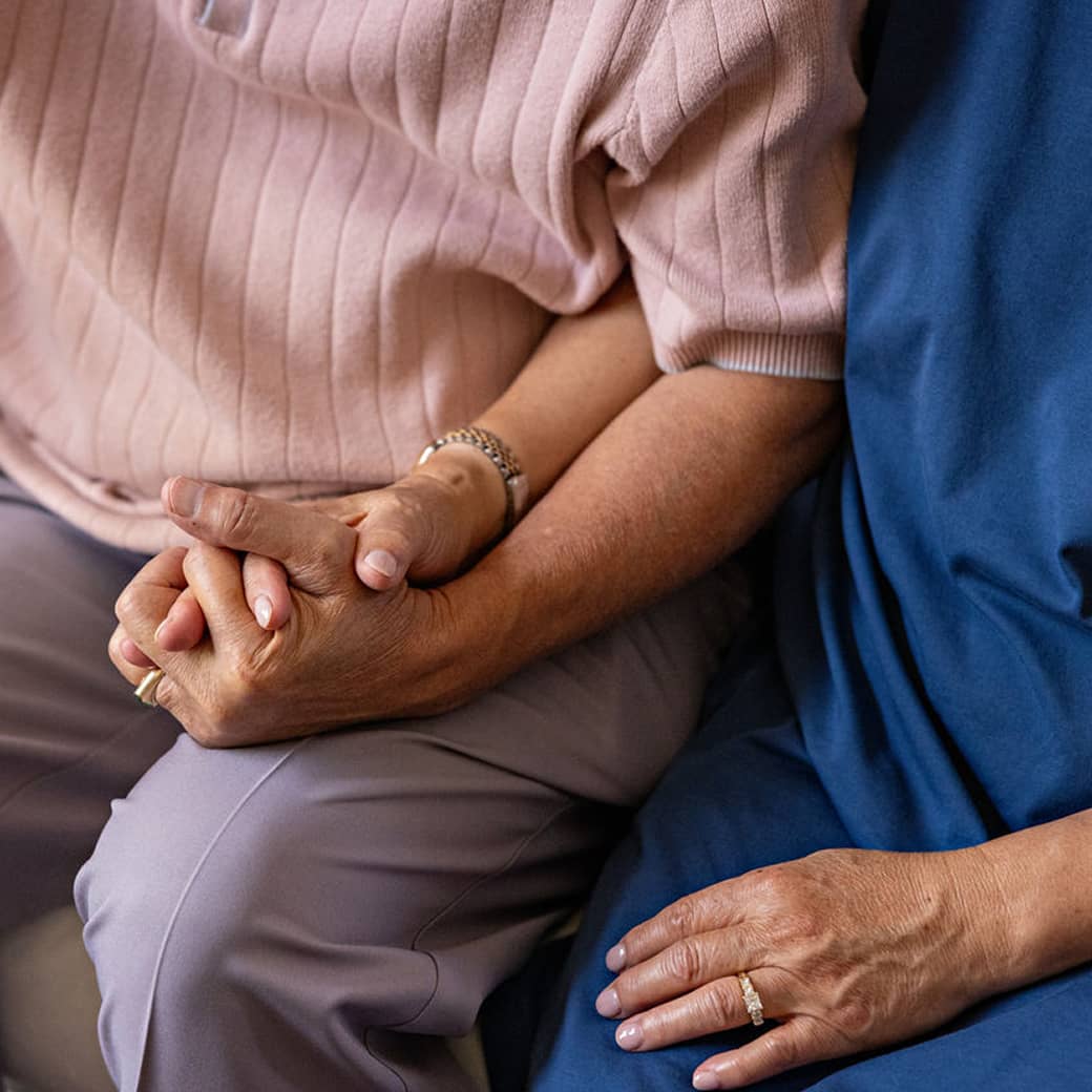 Two people holding each other's hand.