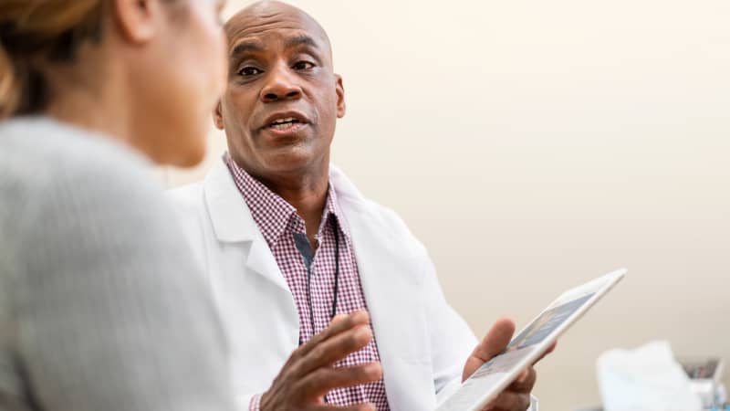 A practitioner explaining tube feeding to a patient.