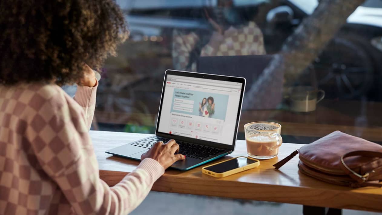 A person looking at the CVS website on their laptop.