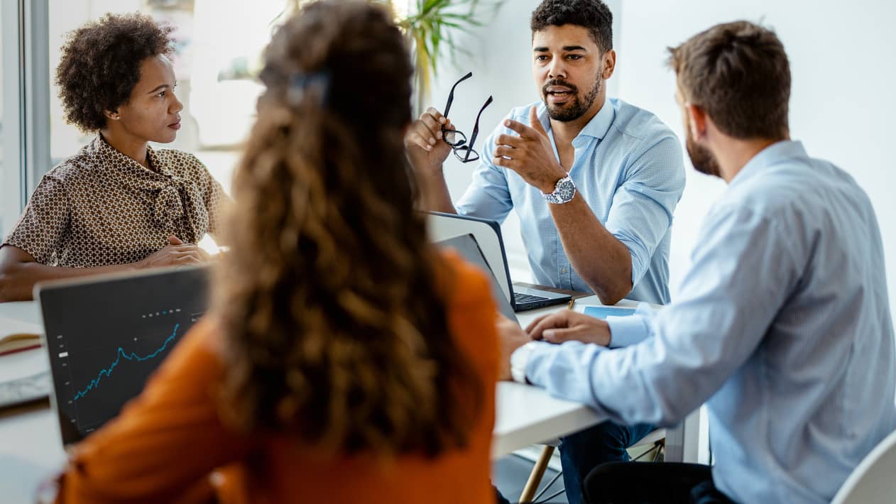 Colleagues in discussion at a conference table