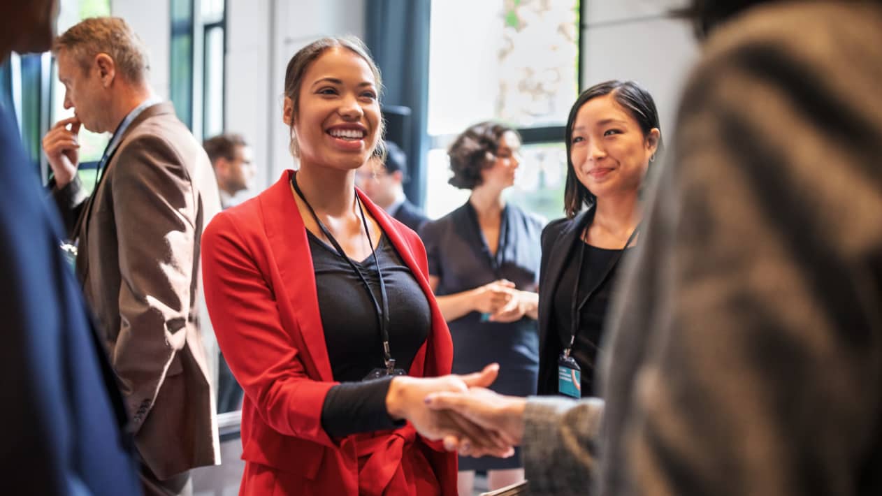 Attendees shaking hands at a gathering.