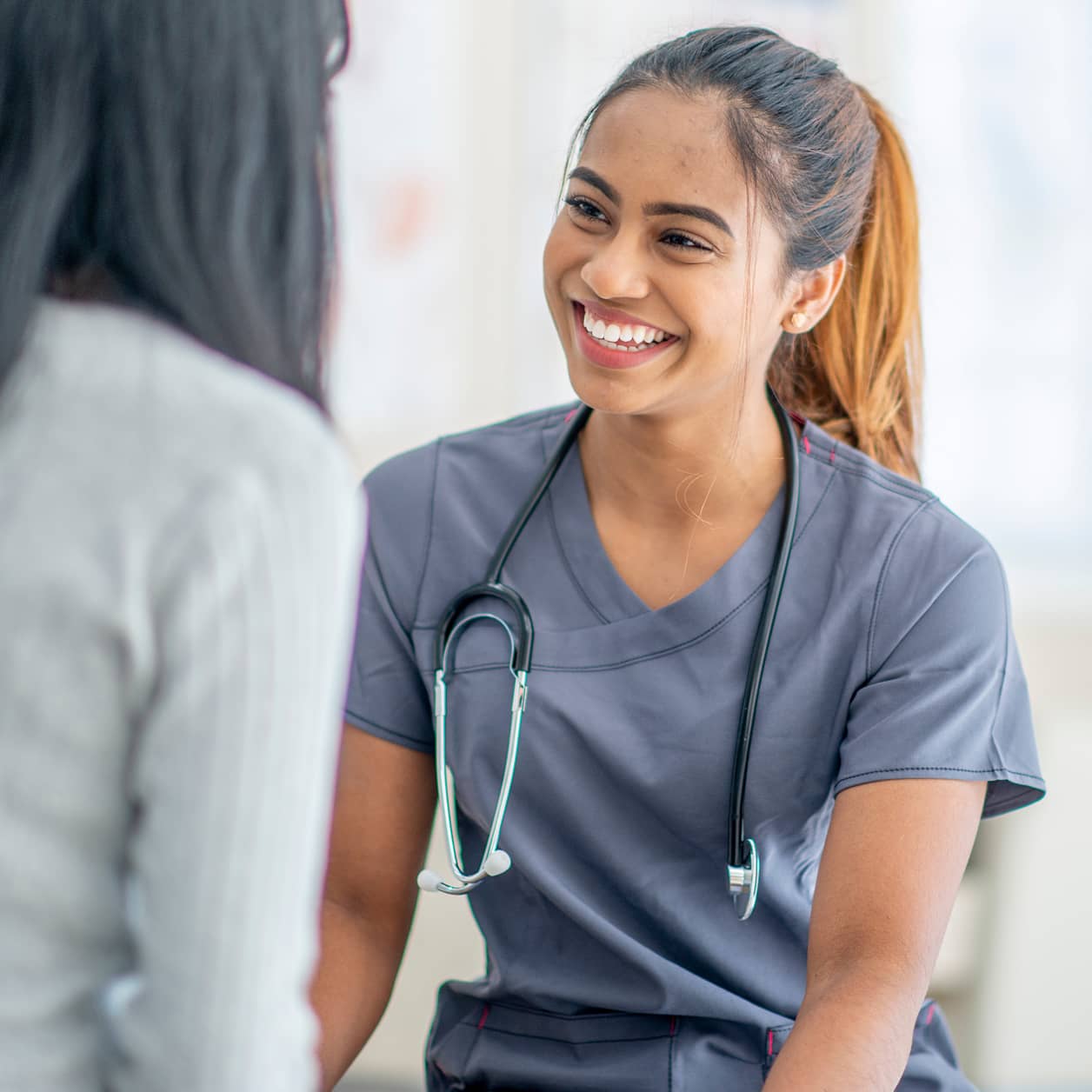 A health care provider smiling at a patient