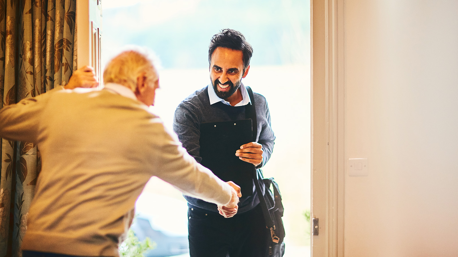 Person greeting a visitor at the door.