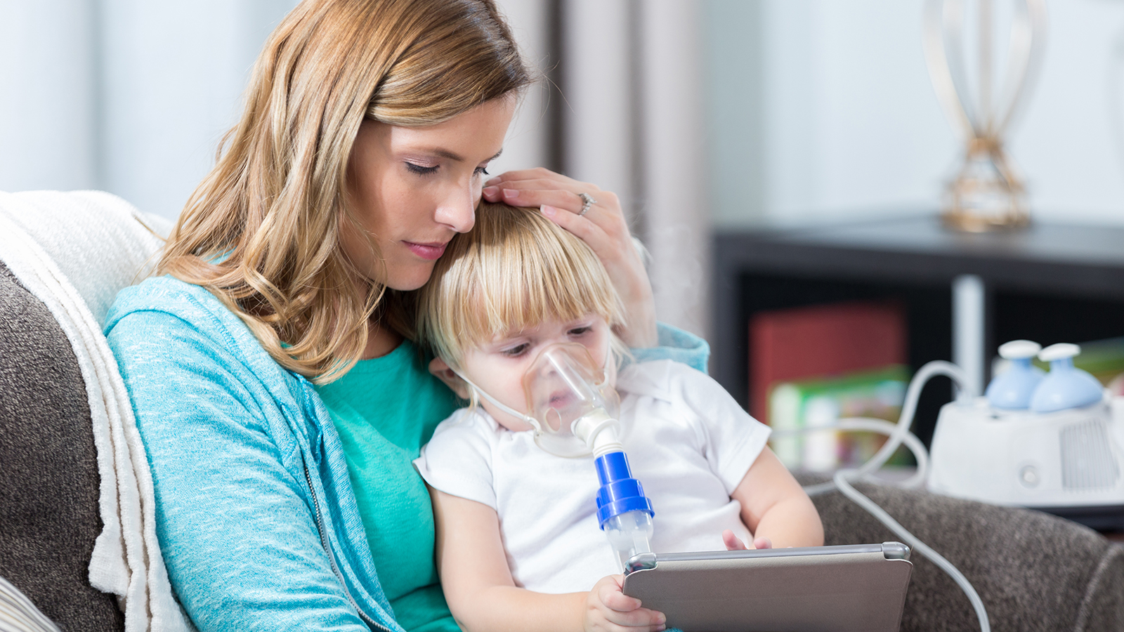 Caregiver assisting a child in a hospital setting