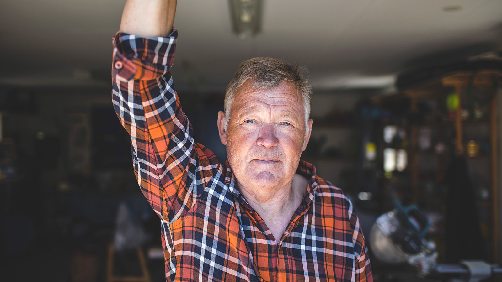 A man raising his arm in a workshop setting
