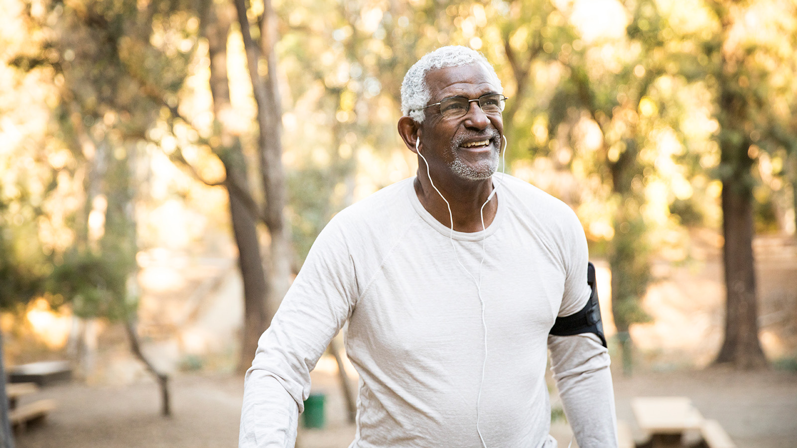 An individual jogging outdoors with headphones on