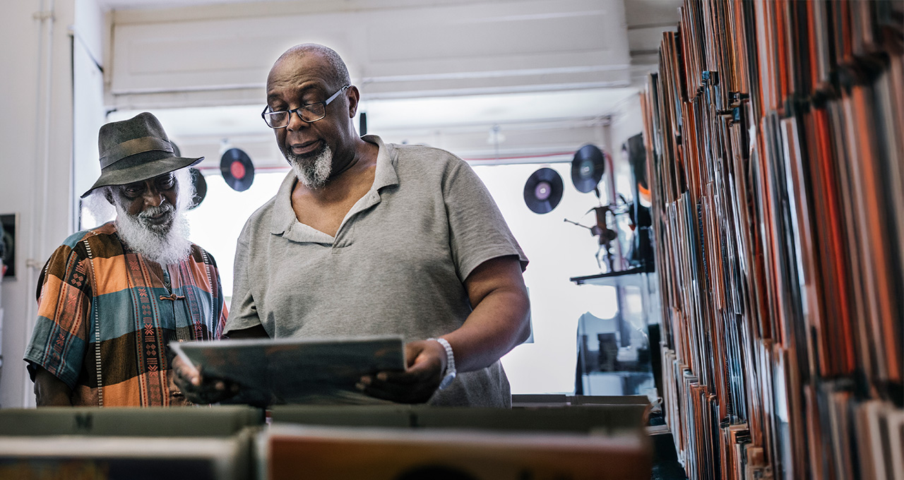 Two men browsing vinyl records in a store